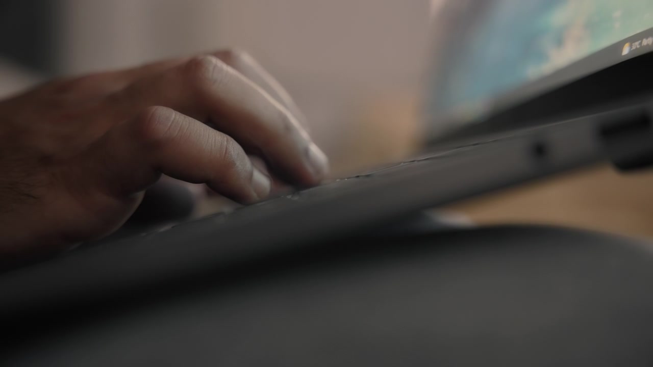 A man typing on a computer keyboard