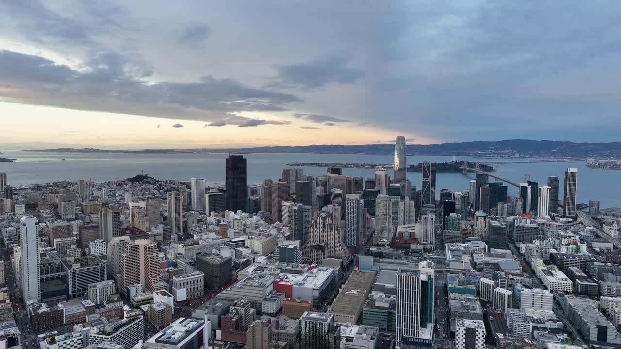 Aerial over San Francisco's scenic urban landscape with skyline and bay views at golden hour