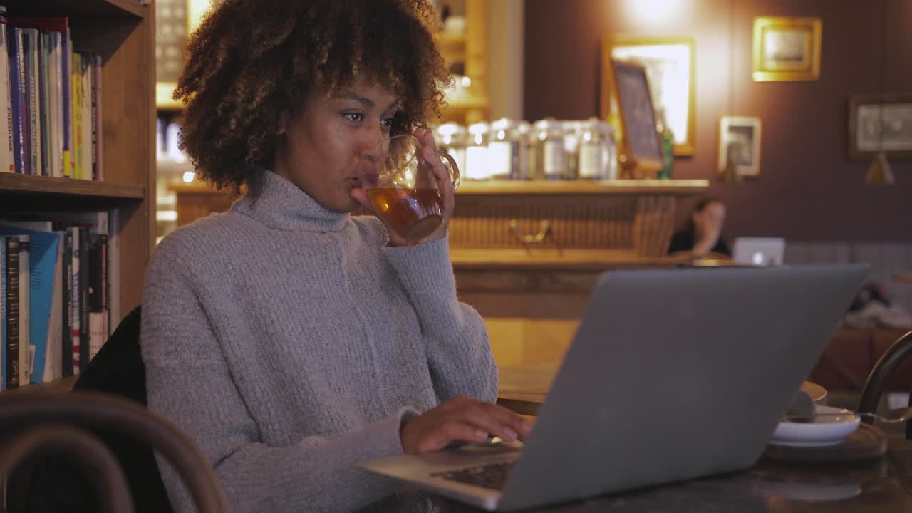 Woman with tea at laptop