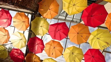 vibrant umbrellas hanging above a street in london