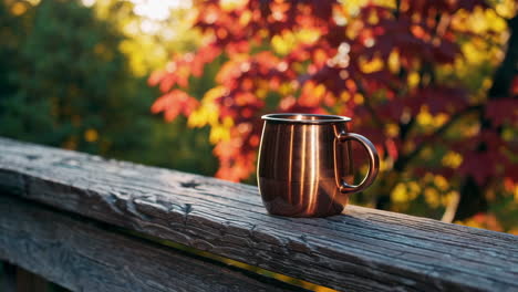 copper mug on a wooden deck in autumn