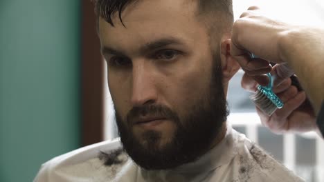 man getting a haircut and beard trim at a barbershop