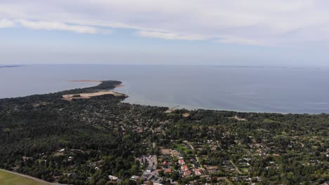 Aerial-view-of-the-coastline-of-Sejerøbugten-with-hills,-fields-and-ocean