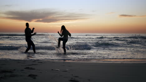 couple are running into ocean