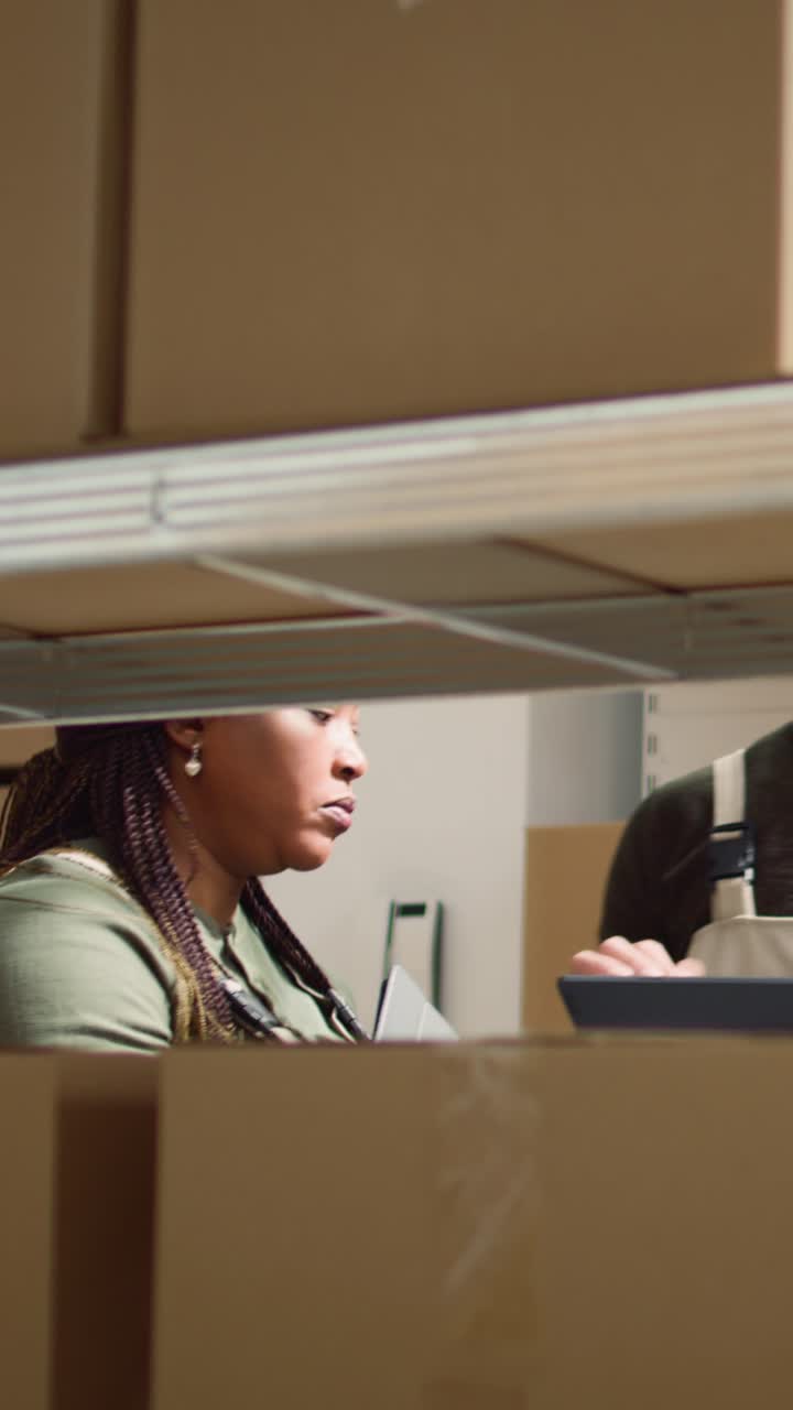Vertical video Workers prepare warehouse delivery order
