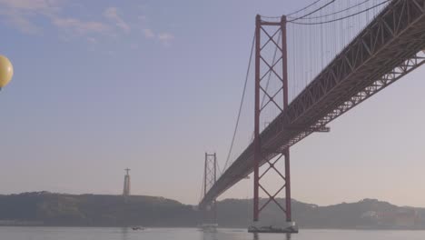 a beautiful view of the abril bridge of lisbon, spain.