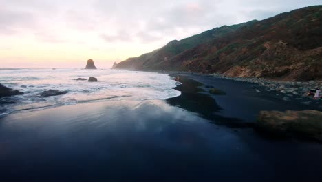 fpv shot of the beach, too close to the ground, in the sun set in tenerife, canary island