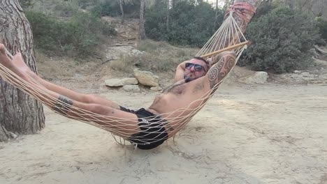 man in a hammock on the beach