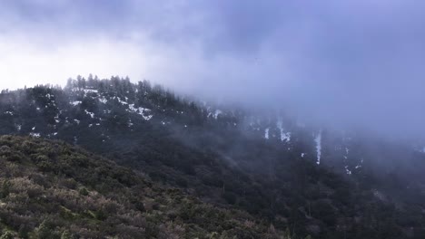 dramatic cloud coverage moving swiftly over the snow covered pine forest mountains of frazier park southern california 60fps
