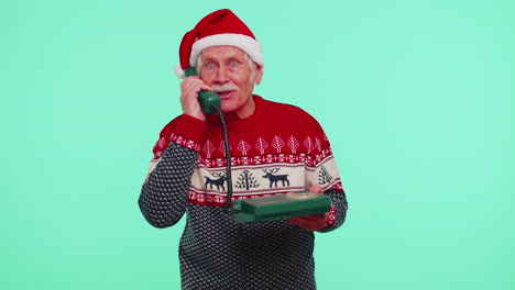 senior christmas grandfather man talking on wired vintage telephone of 80s, say hey you call me back