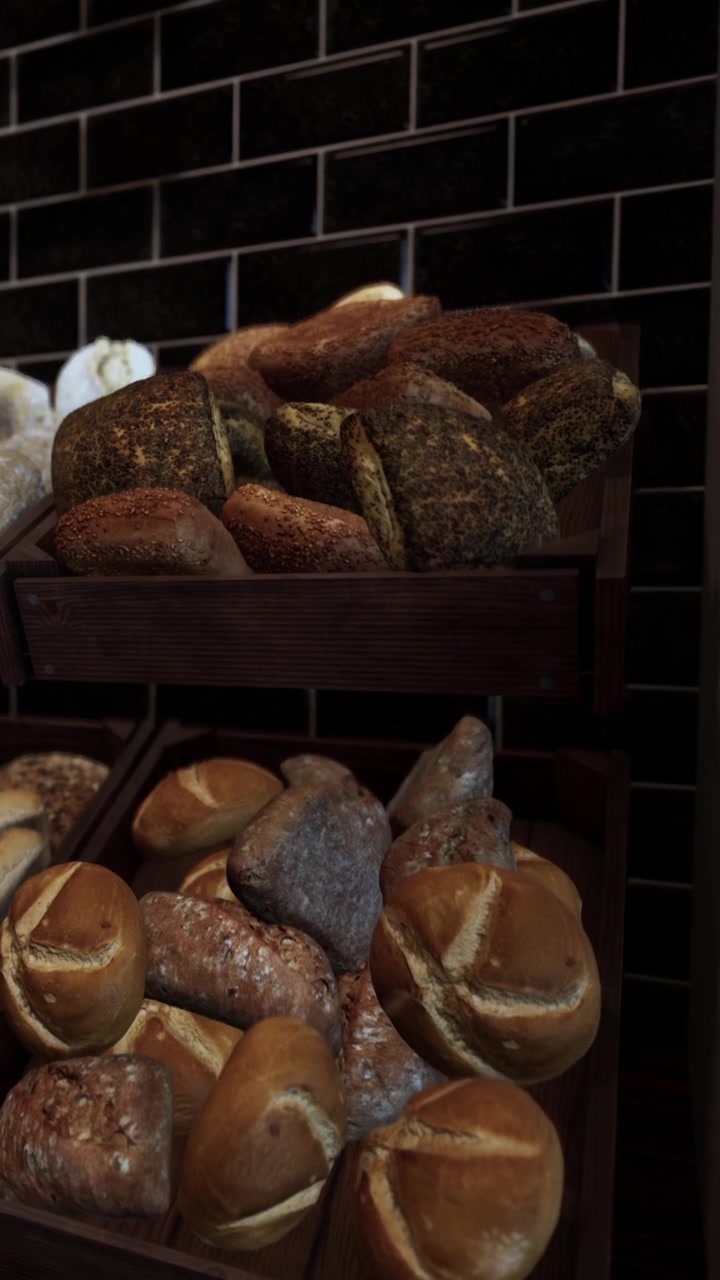 Freshly baked bread varieties displayed on wooden shelves in a bakery