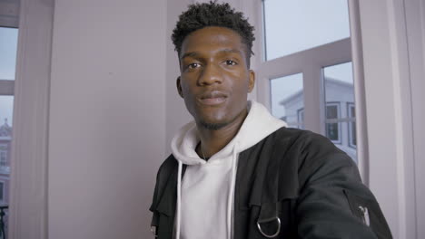 portrait of smiling young man nodding head during video call