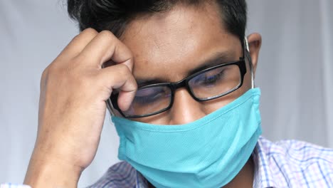 man wearing mask, stressed or sick