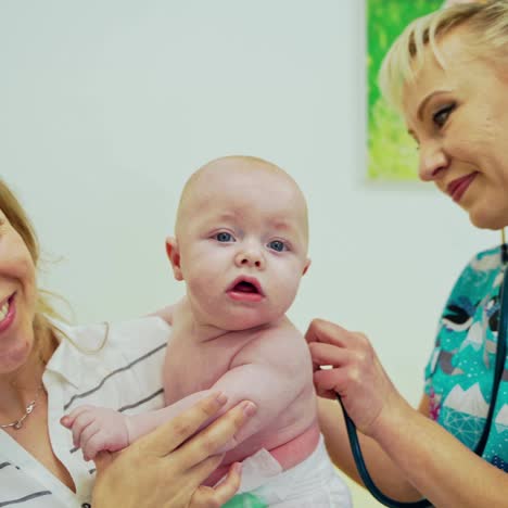 female doctor examining baby in clinic