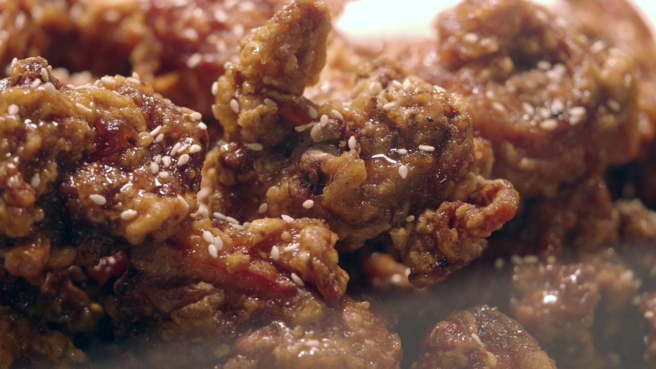 Delicious Steaming Fried Chicken with Sesame Seeds and Glaze