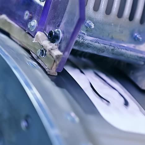 stainless steel shaft rotating to release one of the layers for nappies. a modern enterprise for the production of diapers close up