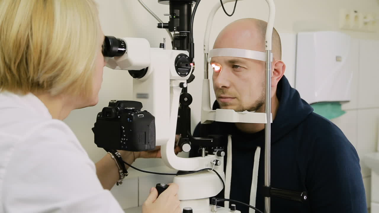 Man taking eye test examination. Ophthalmologist doing eye test on man patient in clinic