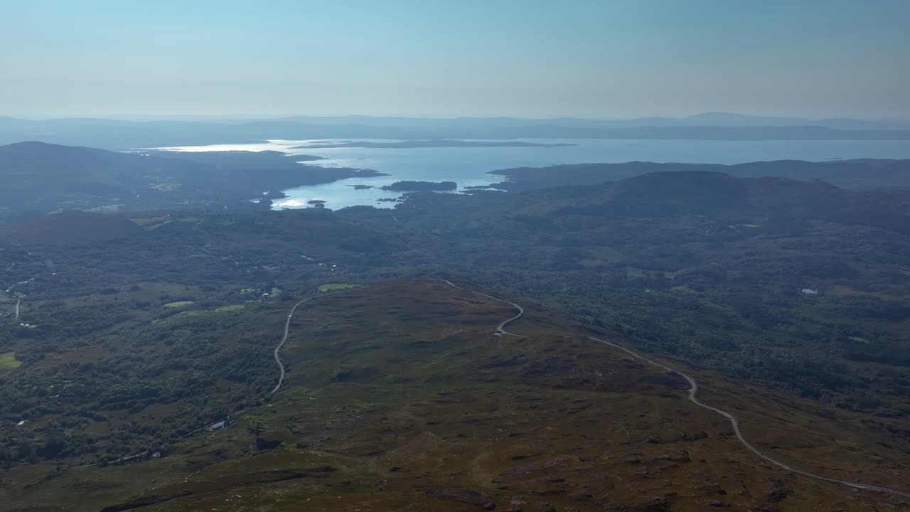 Stunning Aerial View of Irish Mountain Landscape with Winding Road and Serene Lake