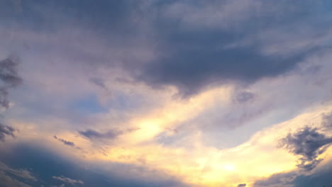 beautiful sky lit with the setting sun. clouds changing shapes and accumulating into dark cloudscape. low angle view. timelapse.