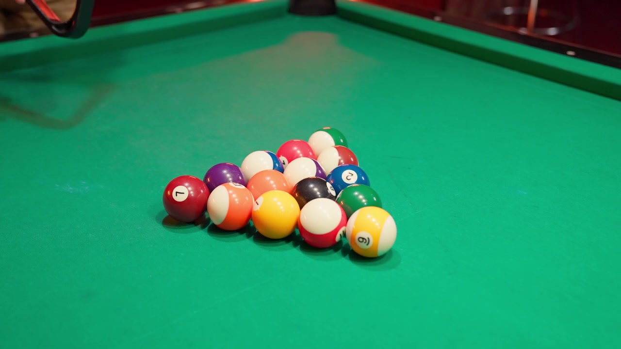 Close-Up of Hands Racking Billiard Balls on Pool Table