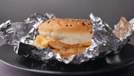 beef burger and french fries in a takeaway paper box on table