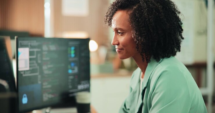 Professional Woman Working on Computer Code in Modern Office