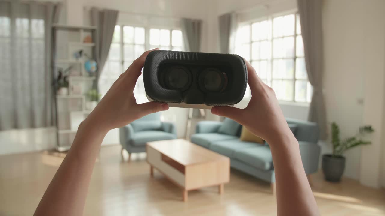 Person Holding VR Headset in a Modern Living Room