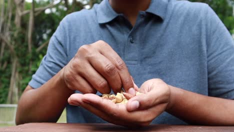 young men eating mux nut sitting on park