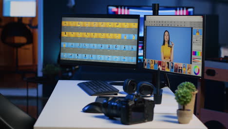 freelancer studio desk with computer screens used for photo processing, graphic tablet and camera