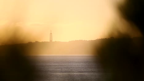 scenic landscape view of the sunset and sanctuary of christ the king monument in the background, portugal