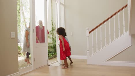 Grandparents-embracing-their-grandchildren-at-home