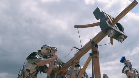 roman soldiers operating a catapult