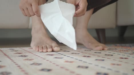 person applying a foot mask for skincare
