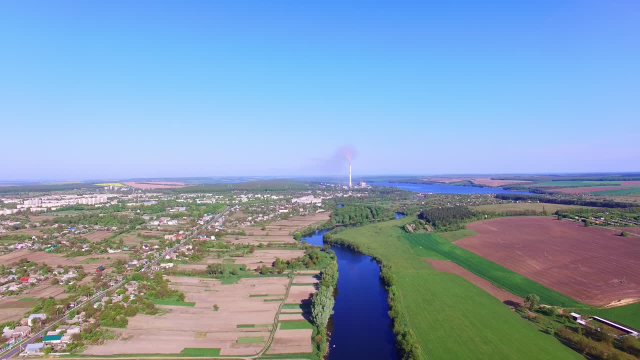 Outstanding panorama of city locating in beautiful nature. Dark blue thin river dividing the area. Blue sky at backdrop .