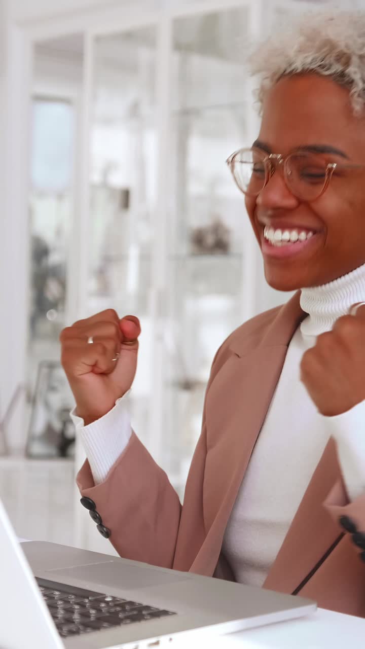 Young woman focused on her laptop in a bright modern workspace setting