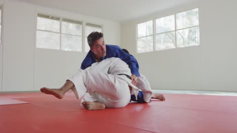 judokas fighting and immobilizing on the ground