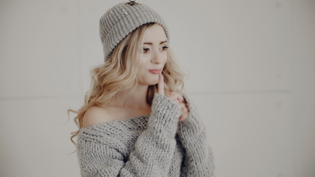 Woman portrait in Christmas room. Young pretty woman with fashion hair and makeup posing at Christmas interior