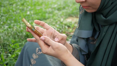 woman using smartphone in a park