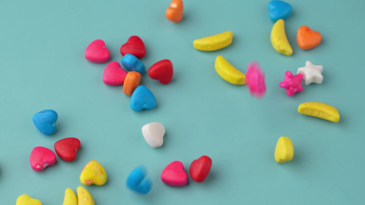 Caramelos de colores cayendo sobre fondo azul