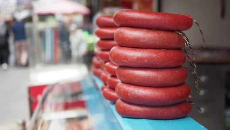 stacked rings of turkish sucuk sausage at a market stall