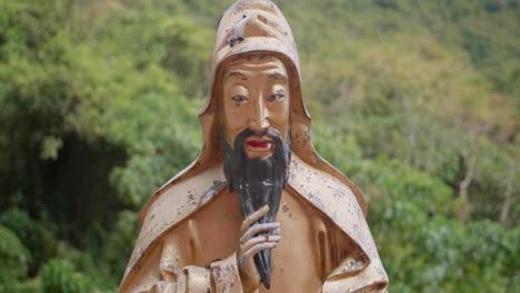 old golden buddha statue looking at the camera