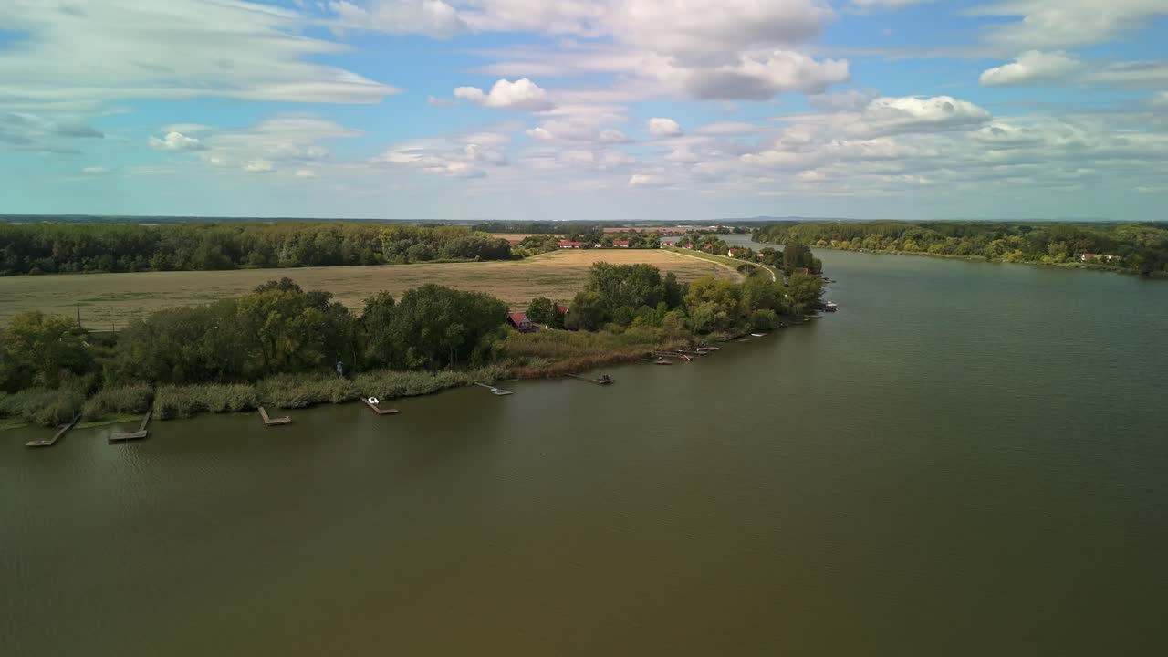 Vista aerea del ramo del Danubio Ráckeve vicino a Dömsöd, che mostra foreste fluviali, campi e piccoli moli di pesca lungo la costa calma