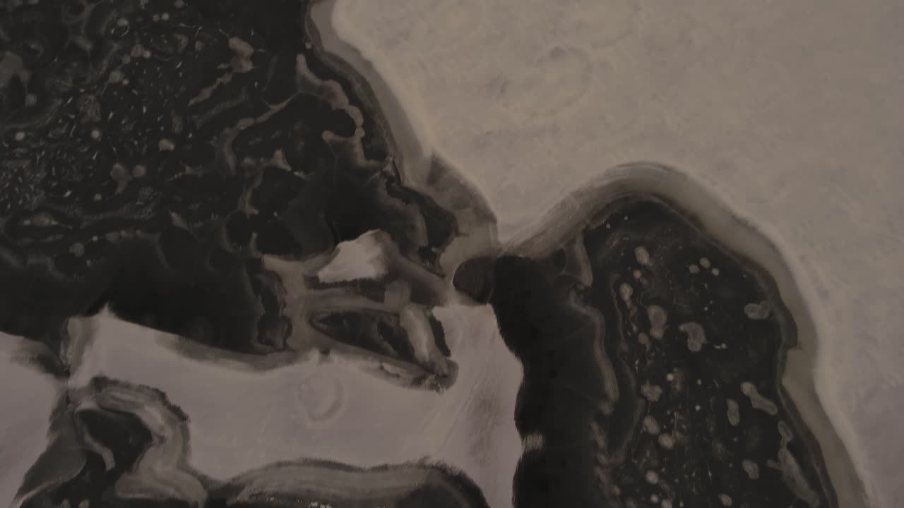 Tracking the surface of a lake, interesting ice formations mixed with snow