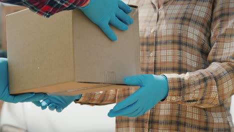 handing the parcel to the recipient in the background of a white delivery service van