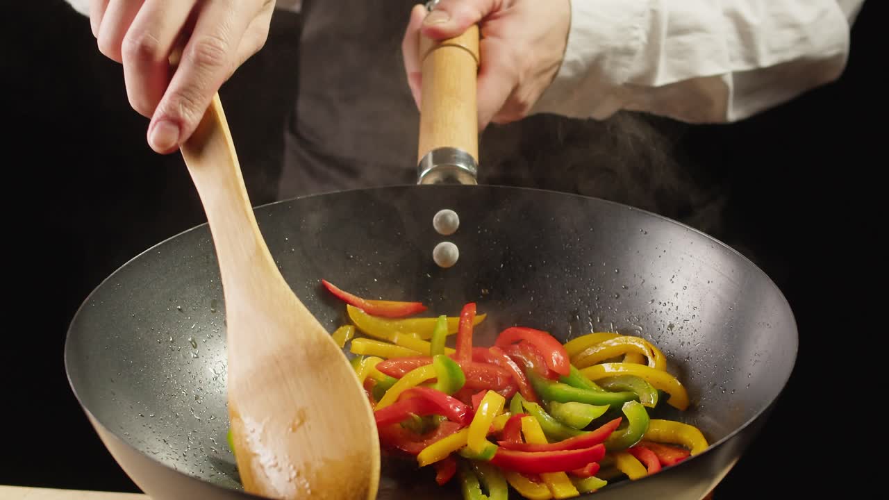 Chef Cooking Stir-fried Peppers in a Wok