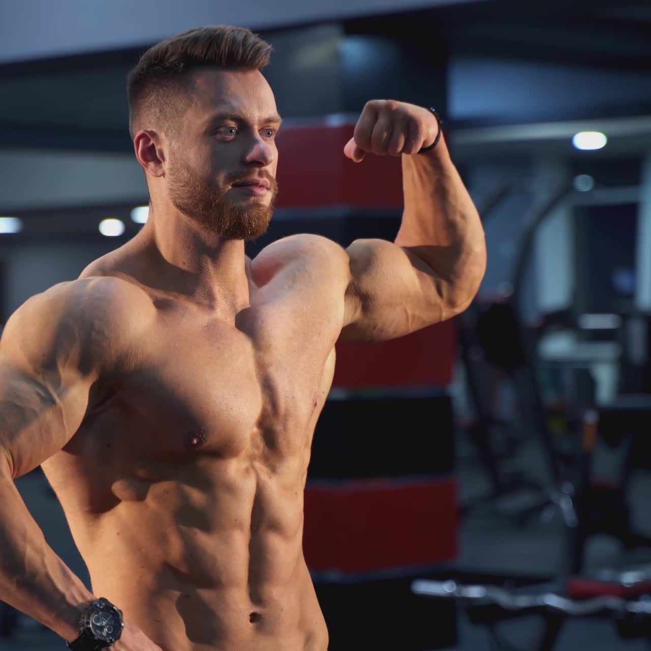 Handsome bodybuilding man have a rest after training. Young shirtless man training hard on the gym