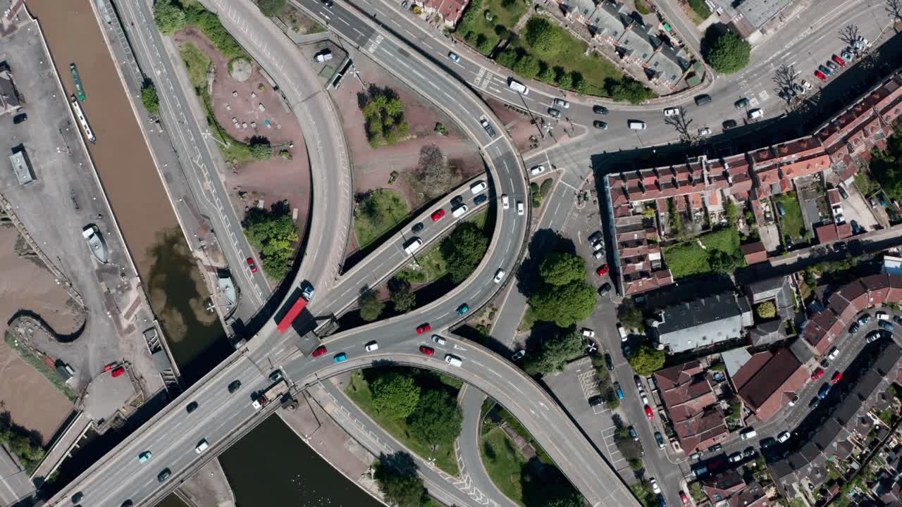 Rising drone shot of complicated road junction over bristol canal