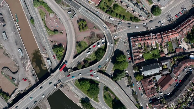 Rising drone shot of complicated road junction over bristol canal