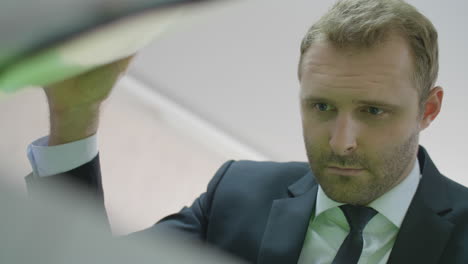 attractive business man in suit using photocopier machine