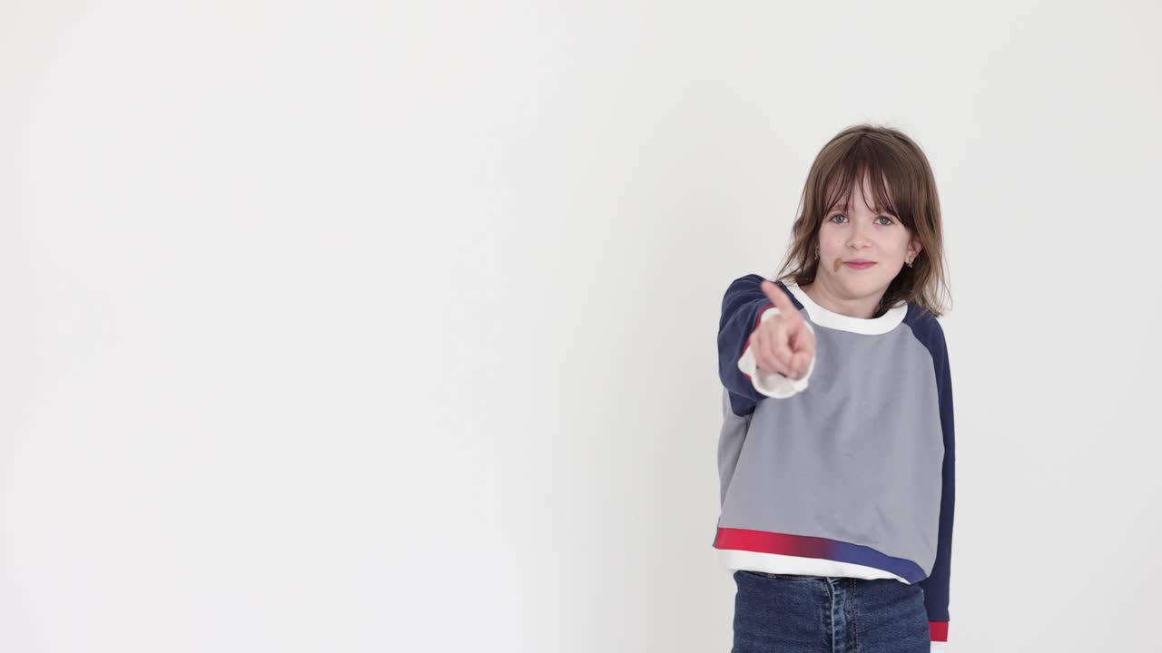 Young Girl Pointing Her Finger on a White Background